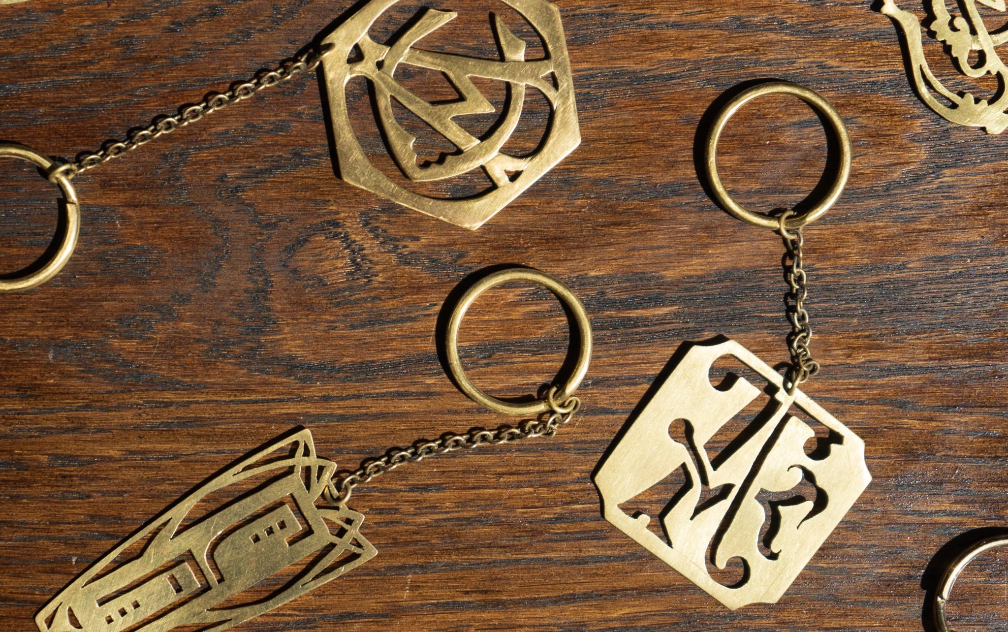 three custom monogrammed gold keychains
