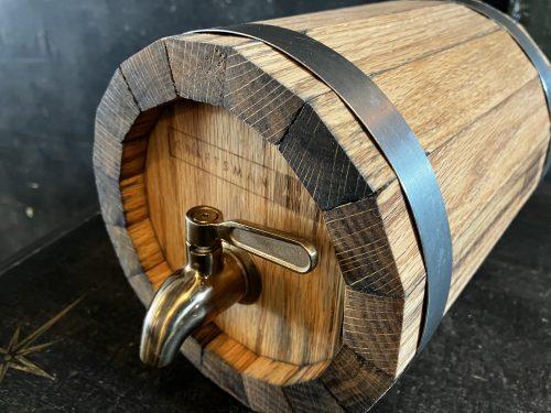 Wooden whiskey barrel with Craftsman Ave's logo burned onto front