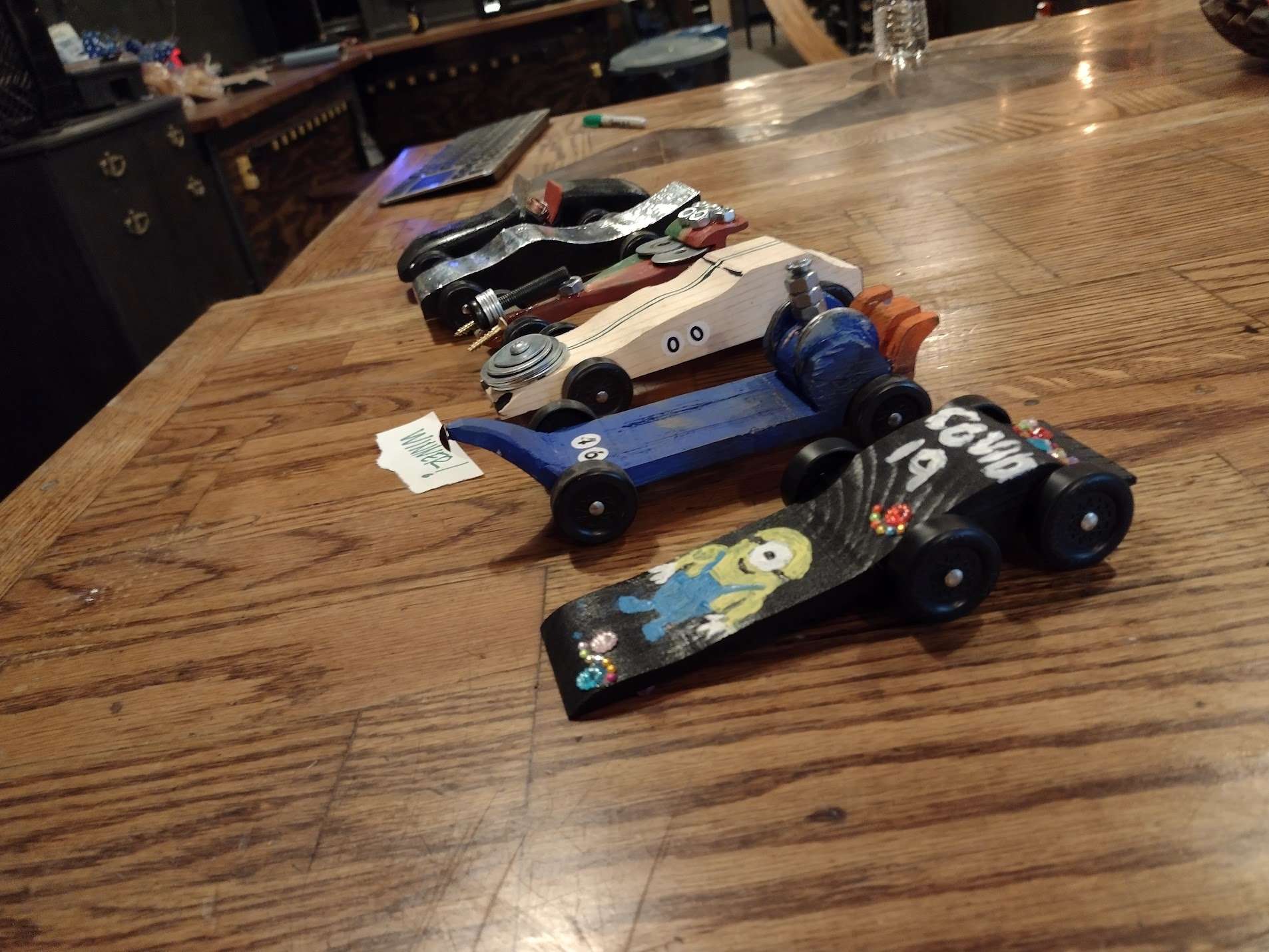 Toy cars made in pinewood derby workshop class at Craftsman Ave