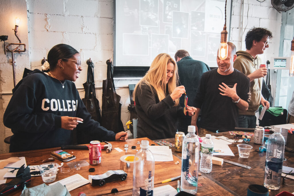 A group of people laugh while taking a team building corporate event at Craftsman Ave in Brooklyn