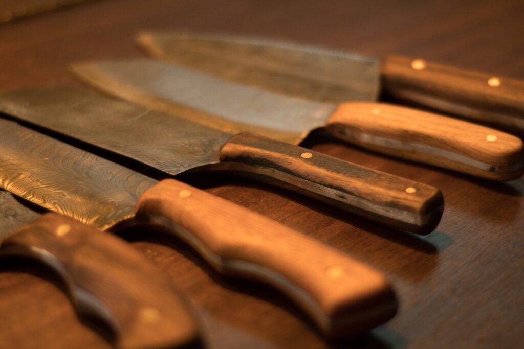five handmade knives with wooden handles