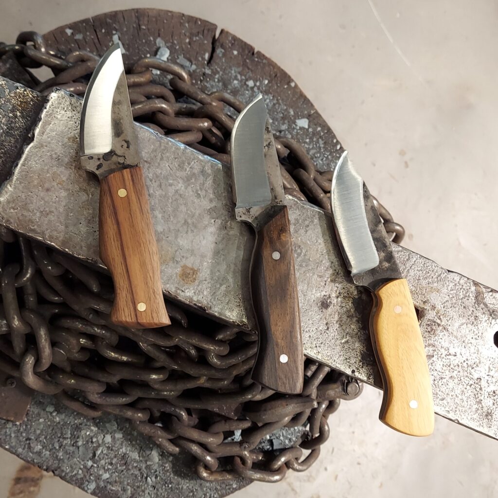 a collection of knives with wooden handles